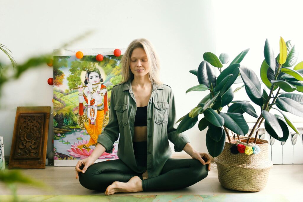 Woman Sitting on the Floor While Meditating